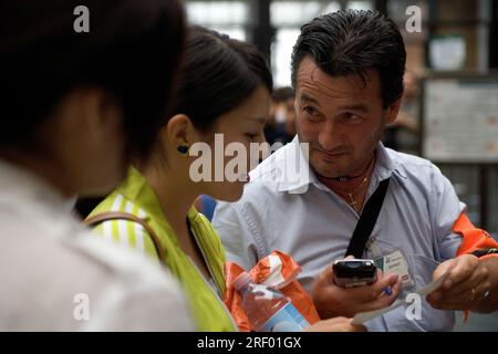 Trenitalia platform staff helping passengers at Milan's busy mainline railway station, the Italian national railway system, 2005 Stock Photo