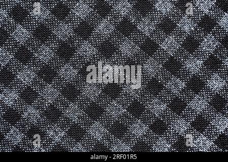 Texture of black and white fabric in a cage. Checkered material. Textile with intersecting white and black lines Stock Photo