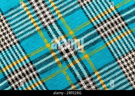 Texture of checkered blue fabric.Textile with intersecting white, black, yellow, blue lines. Pattern. Cell Stock Photo