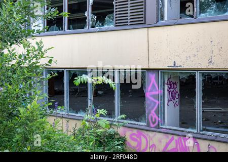 Vandalized abandoned industrial building with tags and broken windows in Paimio, Finland Stock Photo
