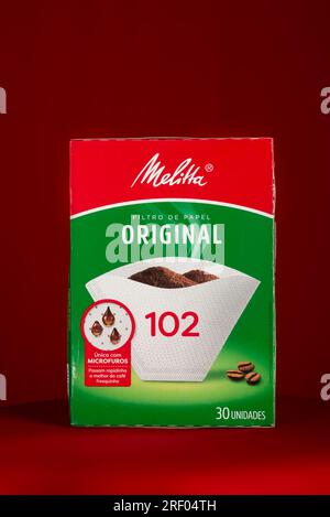 Salvador, Bahia, Brazil - July 30, 2023: Melitta brand paper filter packaging for straining coffee, isolated on a red background. Stock Photo