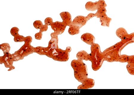 Red jam splashes isolated on a white background. Top view. Stock Photo