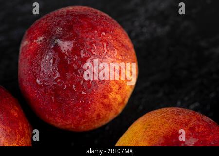 ripe delicious and fresh peaches of a red hue, fresh peaches ready for cooking on the table Stock Photo