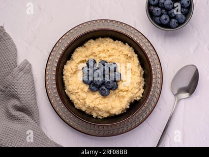 Food photography of millet porridge; blueberry; fibre; ripe; vegan; lifestyle; dish; berry; homemade; ingredient; grain; morning; cereal; Stock Photo