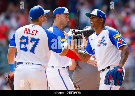 Atlanta Braves relief pitcher Raisel Iglesias, right, reacts with first  baseman Matt Olson, center, and third baseman Austin Riley (27) following  their victory over the Milwaukee Brewers in a baseball game Sunday