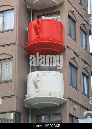 Giant coloured tea-cups adorn the corner of a multi-storey building on the southern end of Kappabashi Street, a shopping district for kitchen items. Stock Photo
