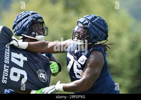 Seattle Seahawks center Joey Hunt (62) and offensive tackle Jalen McKenzie  (76) run a drill during the NFL football team's training camp, Wednesday,  Aug. 9, 2023, in Renton, Wash. (AP Photo/Lindsey Wasson