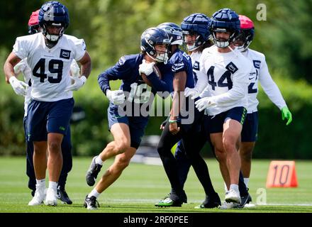 Seattle Seahawks linebacker Lakiem Williams, left, and fullback Nick Bellore,  right, celebrate after a play against the Denver Broncos during the second  half of an NFL football preseason game, Saturday, Aug. 21