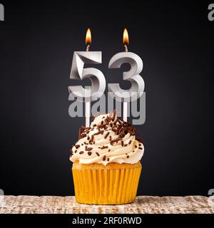 Birthday candle number 53 - Anniversary cupcake on black background Stock Photo