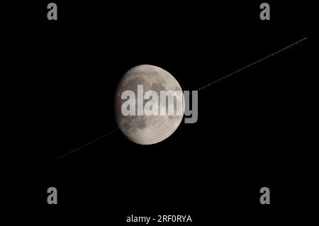 International Space Station (ISS) transiting across the face of the moon, a composite of several photos Ottawa, Canada July 29, 2023 Stock Photo