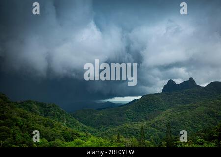 Heavy thunderstorm clouds rolling in on mountains in Panama Stock Photo