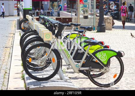 Gira electric bicycles parked at a charging station in one of Portugal’s main squares, showing the popularity of this mode of transport, April 2023. Stock Photo