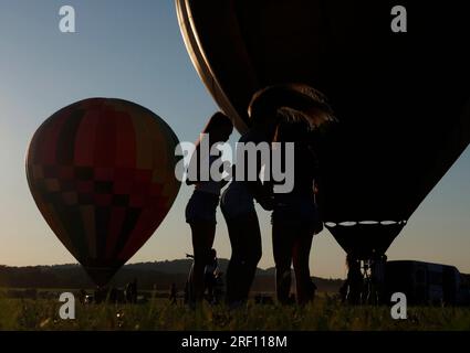 Readington, United States. 30th July, 2023. Hot air balloons are inflated before they take flight at the New Jersey Lottery Festival of Ballooning at Solberg Airport in Readington, NJ on Sunday, July 30, 2023. Photo by John Angelillo/UPI Credit: UPI/Alamy Live News Stock Photo