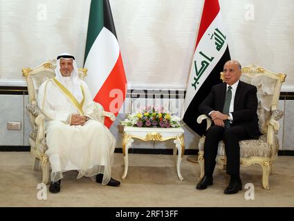 Baghdad, Iraq. 30th July, 2023. Iraqi Foreign Minister Fuad Hussein (R) meets with his Kuwaiti counterpart Sheikh Salem Abdullah Al-Jaber Al-Sabah in Baghdad, Iraq, July 30, 2023. Kuwaiti Foreign Minister Sheikh Salem Abdullah Al-Jaber Al-Sabah paid an official visit to Iraq's capital Baghdad on Sunday and held talks with Iraqi leaders in an attempt to end border demarcation and joint oil field disputes. Credit: Khalil Dawood/Xinhua/Alamy Live News Stock Photo