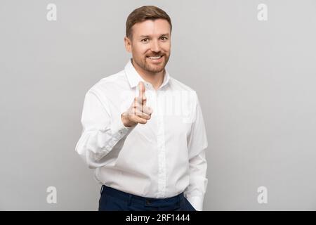 Businessman with smile shows sign of encouragement with fingers of raising spirit of company Stock Photo