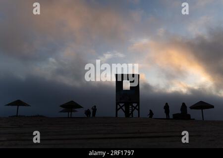 Quintay, Valparaiso, Chile. 29th July, 2023. People walk along the beach at sunset in Quintay, Chile, on a winter day. (Credit Image: © Matias Basualdo/ZUMA Press Wire) EDITORIAL USAGE ONLY! Not for Commercial USAGE! Stock Photo