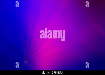 Blurred pink rays from the stage light on a purple background. Purple pink gradient. Stock Photo