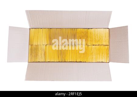 Two stacks of yellow envelopes in a kraft cardboard box isolated on white.  Office supplies Stock Photo - Alamy