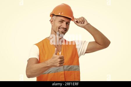 man laborer on background, thumb up. photo of man laborer wearing reflective vest. man laborer isolated on white. man laborer in white studio. Stock Photo