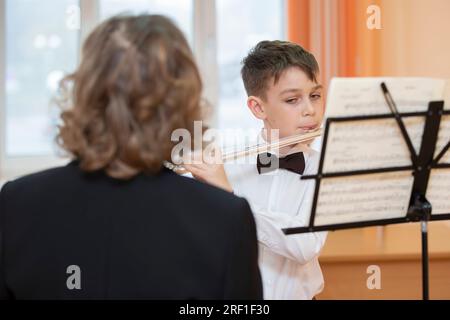 April 20, 2022. Belarus, Gomil city. Music school. A music teacher listens to a student playing the flute in a music school. Stock Photo