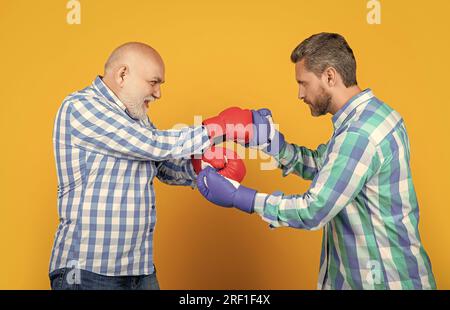 generation men with disagreement in studio, opponent. generation men having disagreement on background. photo of generation men disagreement. two gene Stock Photo