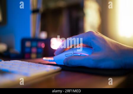 Playing computer game with gaming mouse Stock Photo