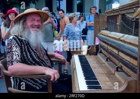 Man with piano on harbour promenade, Lindau, Lake Constance, Bavaria, Germany, playing piano, music, making music Stock Photo