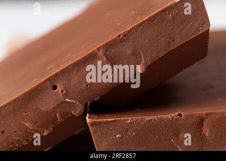 pieces of large natural real chocolate, broken into several parts pieces of chocolate from cocoa, natural food from cocoa, sugar, cocoa butter Stock Photo