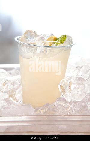 Refreshing mint coconut cooler with ice cubes on a textured background natural light. Stock Photo