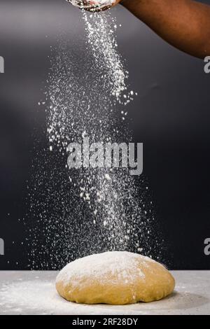 Soko Maize Meal Home Baking FlourCapwell Industries Limited Hand spreading wheat flour on the dough Stock Photo