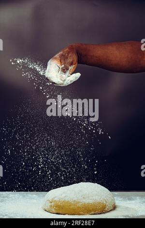 Soko Maize Meal Home Baking FlourCapwell Industries Limited Hand spreading wheat flour on the dough Stock Photo