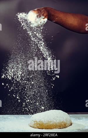 Soko Maize Meal Home Baking FlourCapwell Industries Limited Hand spreading wheat flour on the dough Stock Photo