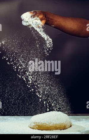 Soko Maize Meal Home Baking FlourCapwell Industries Limited Hand spreading wheat flour on the dough Stock Photo