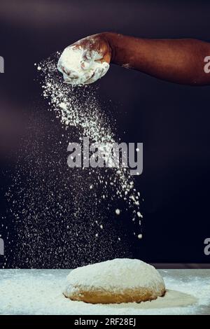 Soko Maize Meal Home Baking FlourCapwell Industries Limited Hand spreading wheat flour on the dough Stock Photo