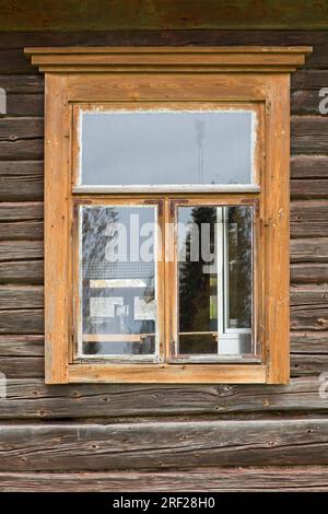 Light brown framed window on old wooden wall. Stock Photo