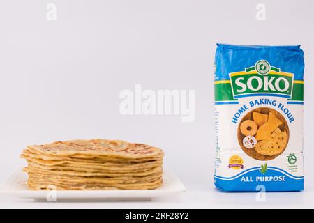 Chapati Mandazi Andazi Samosa triangular-shaped snacks on a plate on a white background in Nairobi city county Kenya east Africa. Food Delicious Dinne Stock Photo