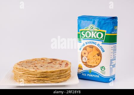 Chapati Mandazi Andazi Samosa triangular-shaped snacks on a plate on a white background in Nairobi city county Kenya east Africa. Food Delicious Dinne Stock Photo