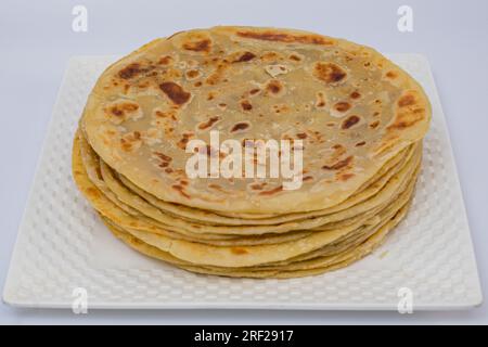 Chapati Mandazi Andazi Samosa triangular-shaped snacks on a plate on a white background in Nairobi city county Kenya east Africa. Food Delicious Dinne Stock Photo