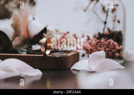Wedding ring close up with blurred background and flowers Stock Photo