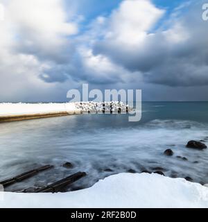 Long exposure shot of tetrapods in the winter sea, Yoichi, Hokkaido, Japan Stock Photo