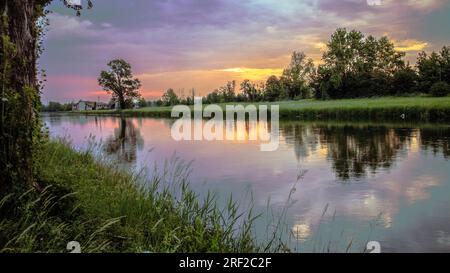 Cloudy sky before storm on river ,Italy Stock Photo