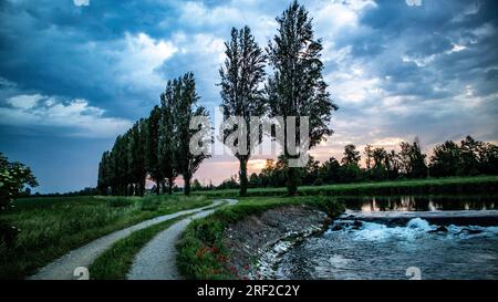 Cloudy sky before storm on river ,Italy Stock Photo