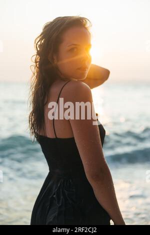 Portrait of a young woman with sun rays on her face Stock Photo