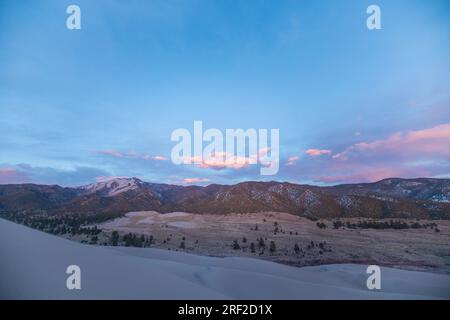 sunset over the foothills of colorado beneath great sand dunes park Stock Photo