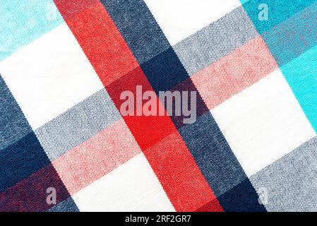 The texture of linen fabric in a large cell of red, blue and white. Scottish tailoring material. checkered fabric Stock Photo