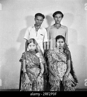 old vintage 1900s black and white studio portrait of Indian family two brothers with their wives India 1940s Stock Photo