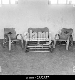 old vintage 1900s black and white picture of Indian cane furniture sofa chairs table India 1940s Stock Photo