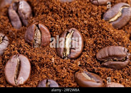 roasted coffee beans are placed on ground coffee, ingredients that can be used to make a hot, invigorating drink, coffee bean powder, and whole coffee Stock Photo