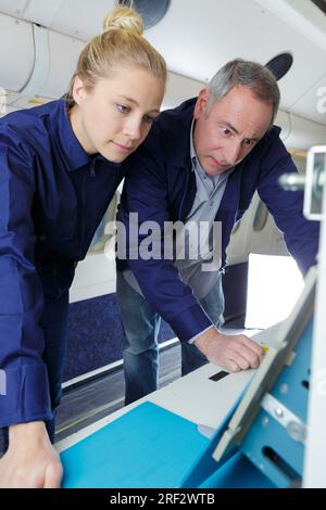 aero engineer and apprentice working on aircraft Stock Photo