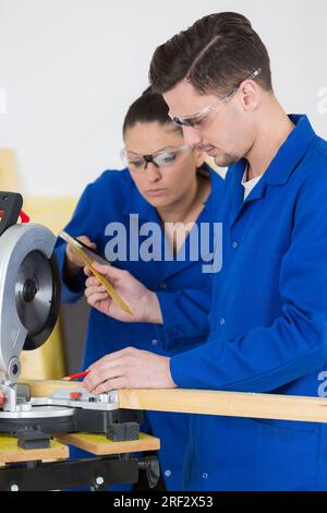 student in carpentry class using circular saw Stock Photo
